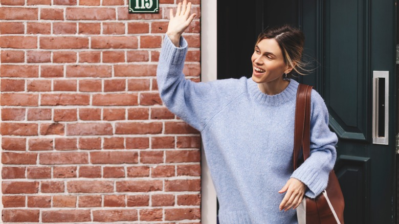 Woman waving goodbye