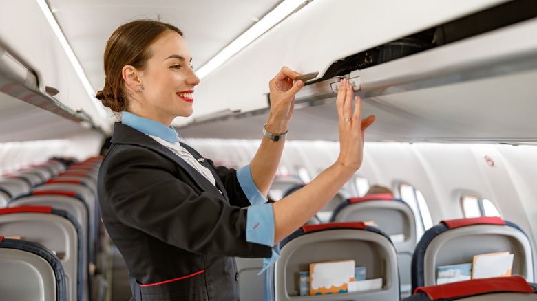 Flight attendant loading baggage