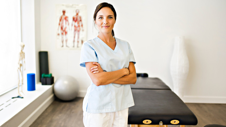 Physical therapist smiling with arms crossed