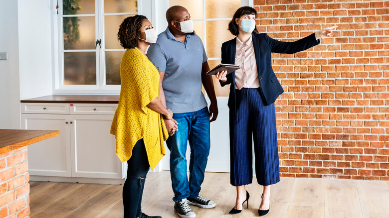 agent showing home to couple