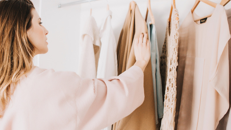 A stylist choosing clothes