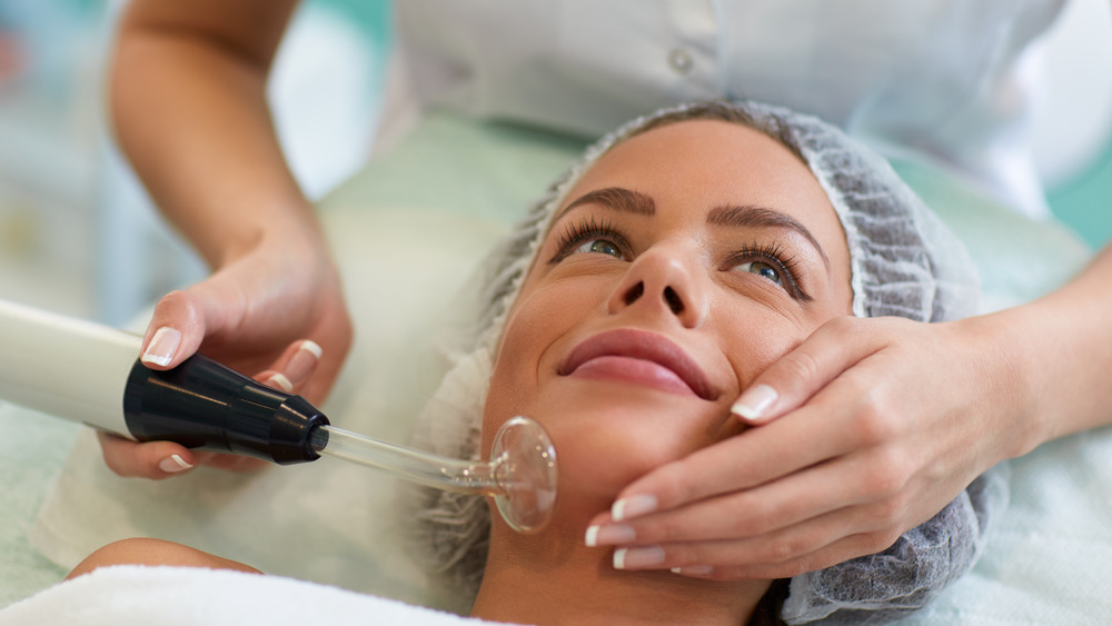 Woman receiving a spot removing treatment 