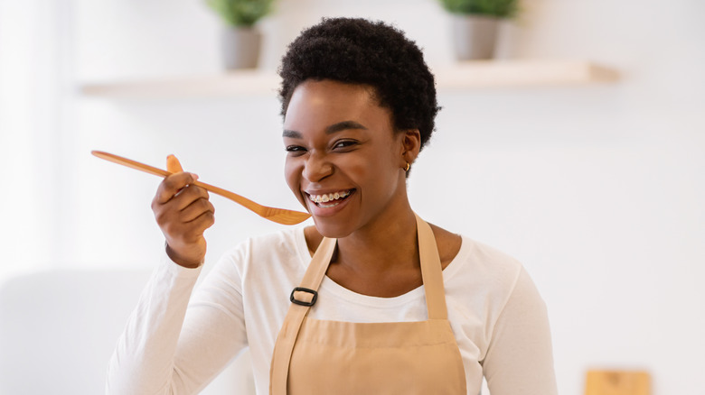 woman tasting from spoon