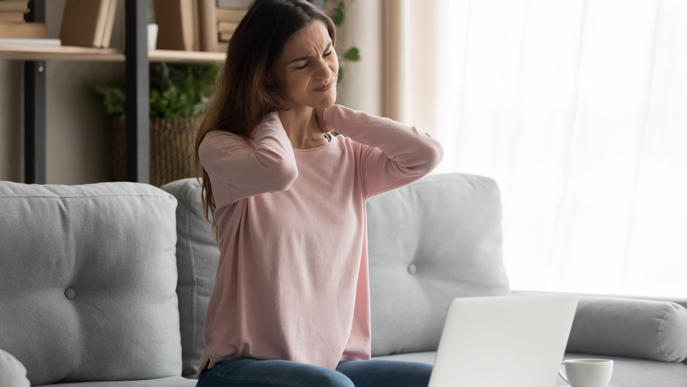 Woman tending to posture pain