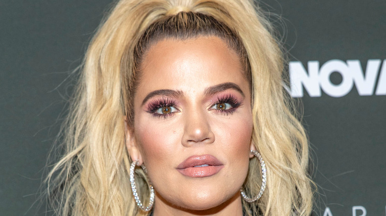 Khloé Kardashian poses on the red carpet