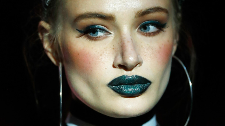 Model wearing green lipstick