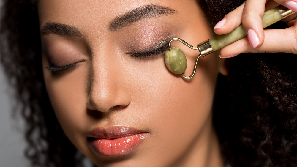woman using jade roller