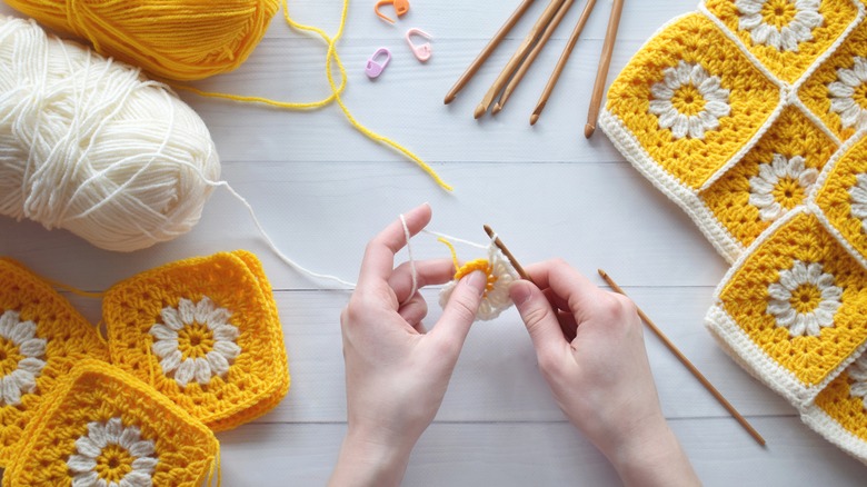 Hands crocheting patches