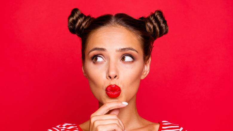 woman with space buns and red lips