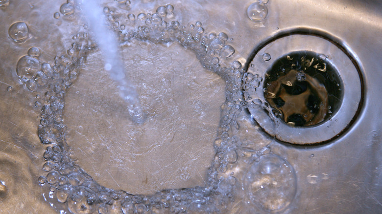 Water running down a kitchen sink drain 