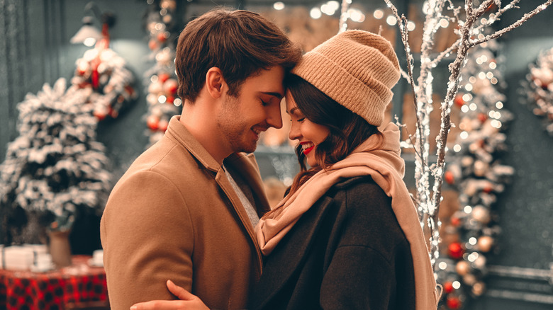 Romantic couple with Christmas decor in background