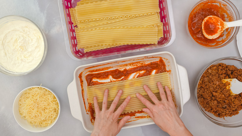 Person assembling lasagna