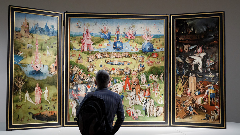 Man looking at The Garden of Earthly Delights 
