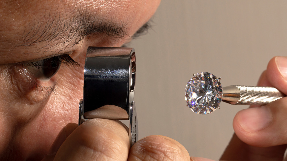 Man looking at a diamond