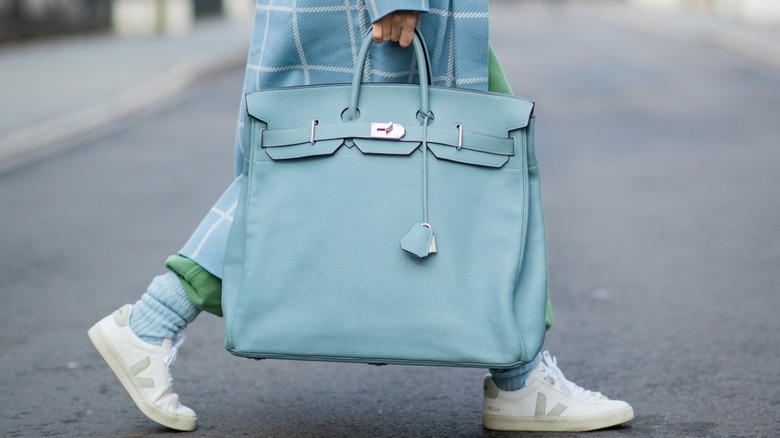 Woman carrying light blue Hermes Birkin bag