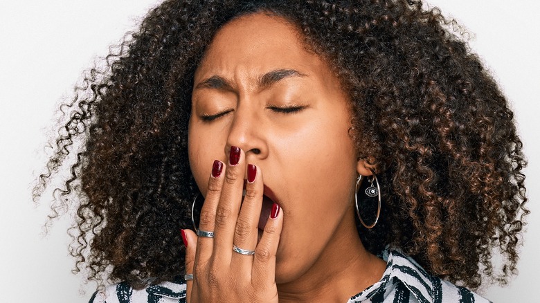 Young woman yawning 