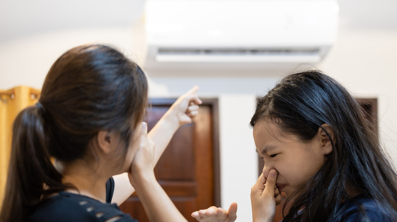 Women reacting to a dirty air conditioner