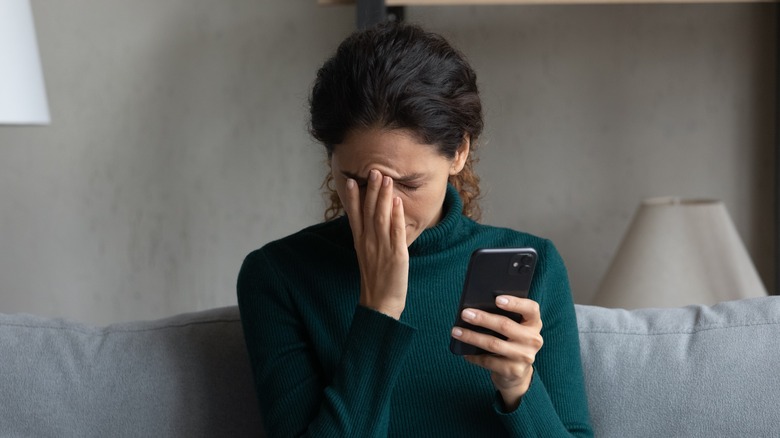Distressed woman with phone