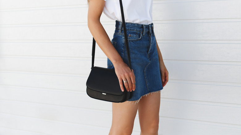 denim skirt with white shirt and purse 