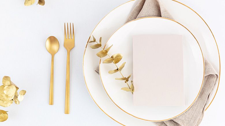 A place setting with a white dish