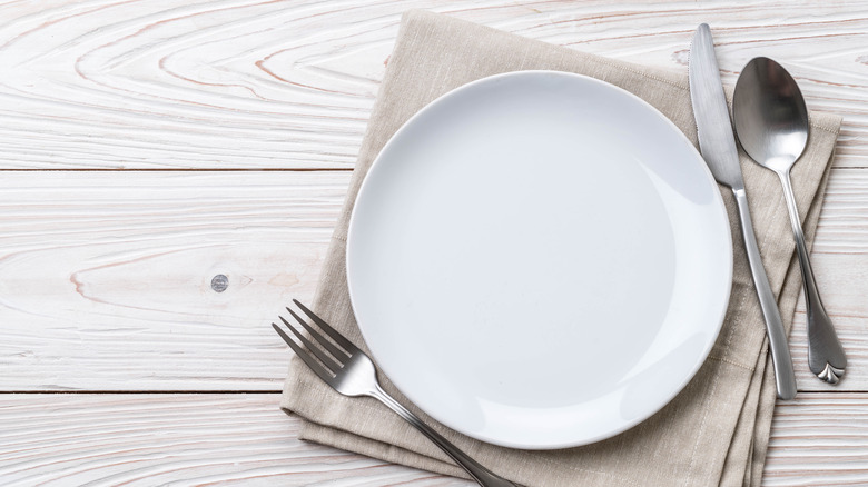 A table setting with a white dish 