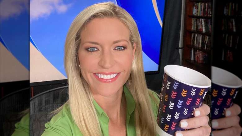 Ainsley Earhardt holds a coffee cup while on the Fox set.