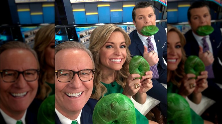 Ainsley Earhardt holding a green bagel with her co-hosts on St. Patrick's Day.