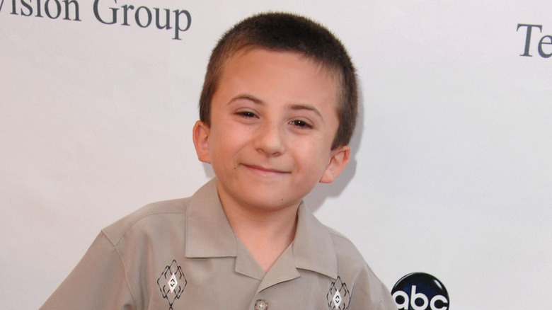 A young Atticus Shaffer smiling on step-and-repeat