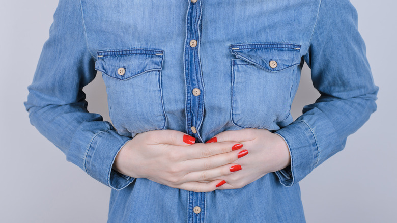 woman holding stomach