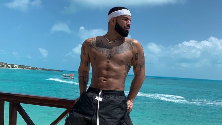 Drake shirtless with tattoos.
