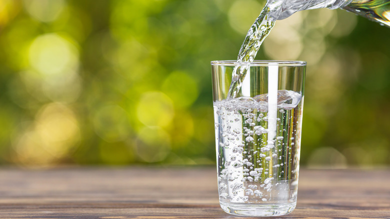 Pouring water into glass 