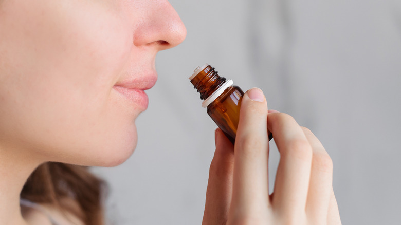 Woman smelling essential oil