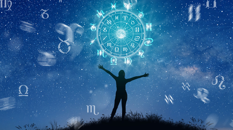 Woman under the sky with the zodiac