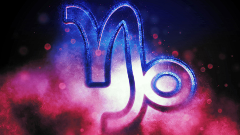 A Capricorn symbol in multi-colored haze