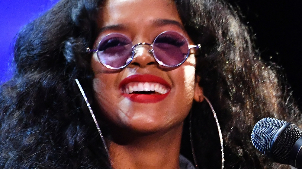 H.E.R. smiling on stage