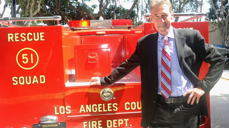 Randolph Mantooth smiling and posing alongside "Emergency!" firefighter vehicle in 2017