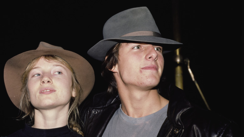 Rebecca De Mornay and Tom Cruise posing in hats