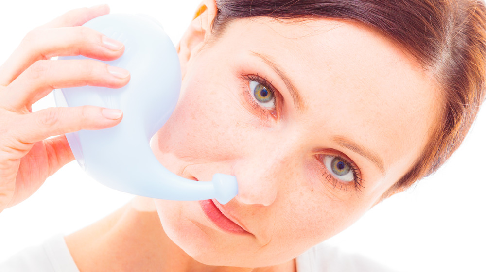 Woman using a Neti pot