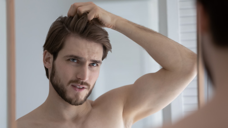 man annoyed with his cowlick