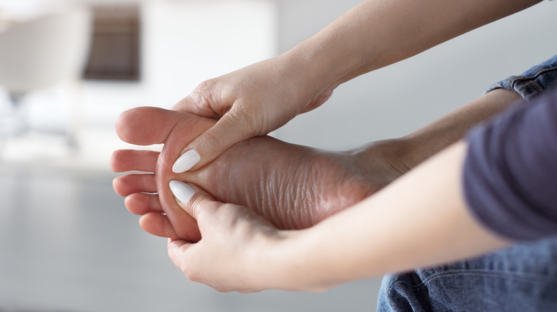 Woman massaging a numb foot