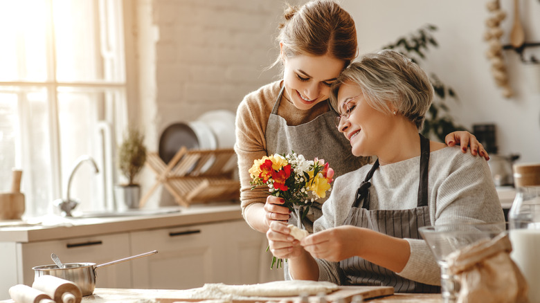 A woman cooking with her grandmother