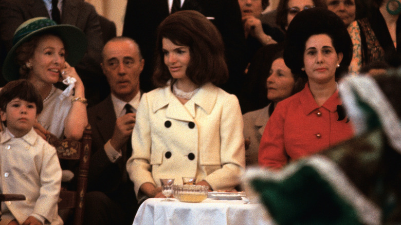 Jackie Kennedy in a crowded room at luncheon event