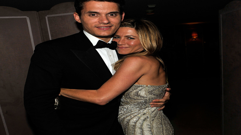 John Mayer and Jennifer Aniston posing at an award show