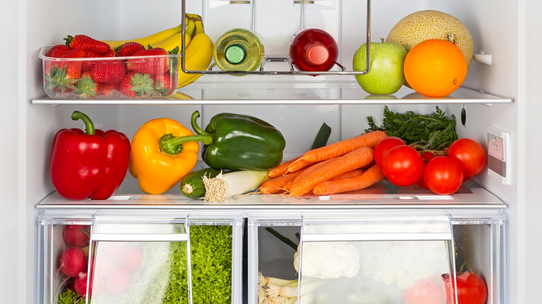 The inside of a fridge with fruit and vegetables