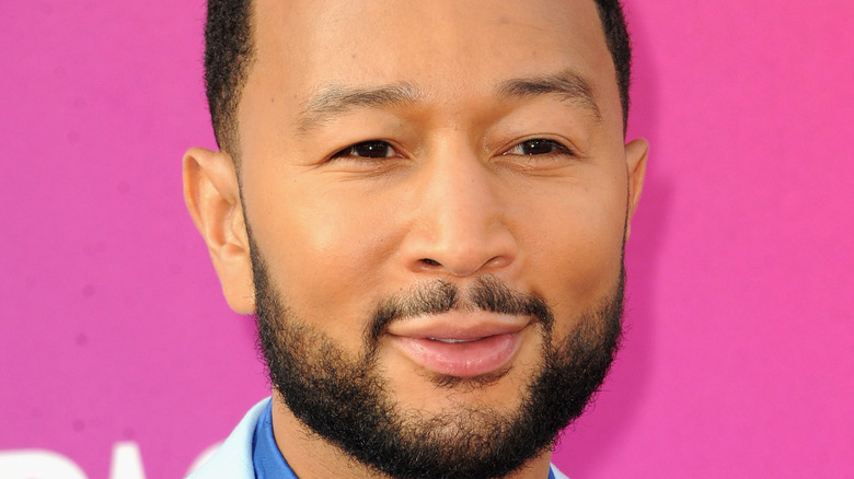 John Legend pink background red carpet