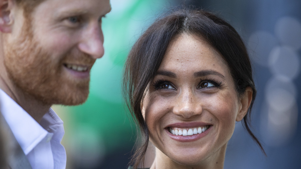 Meghan Markle smiling at Prince Harry