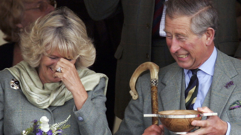 Charles gives Camilla drink