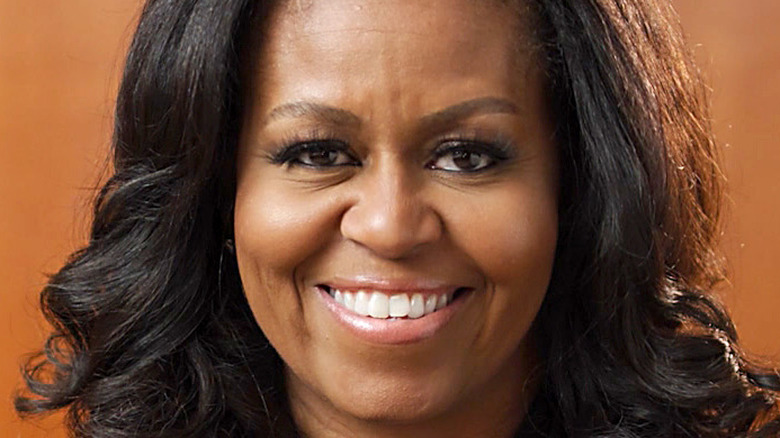 Michelle Obama smiles at an event