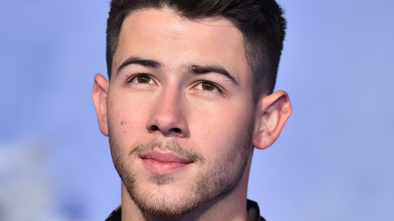 Nick Jonas smirking