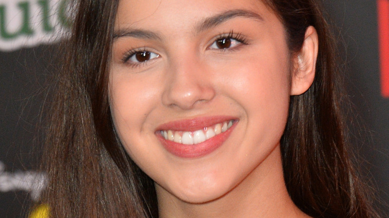 Olivia Rodrigo smiling for cameras